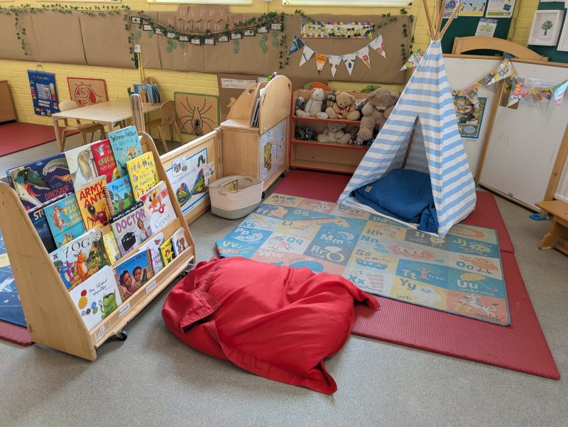 The book corner, with the reading tent and the alphabet rug